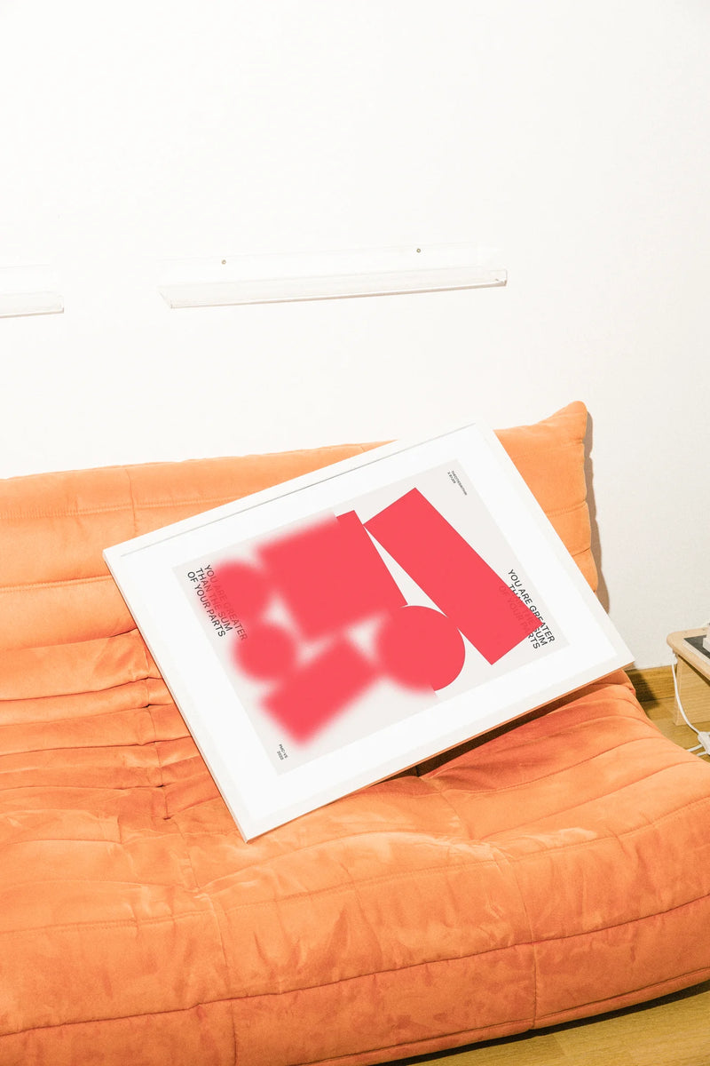 Une illustration numérique minimaliste présentant des formes abstraites rouges audacieuses sur un fond blanc éclatant, encadrant la phrase inspirante 'You Are Greater Than The Sum Of Your Parts'.. abstract, digital, minimalist, red, white