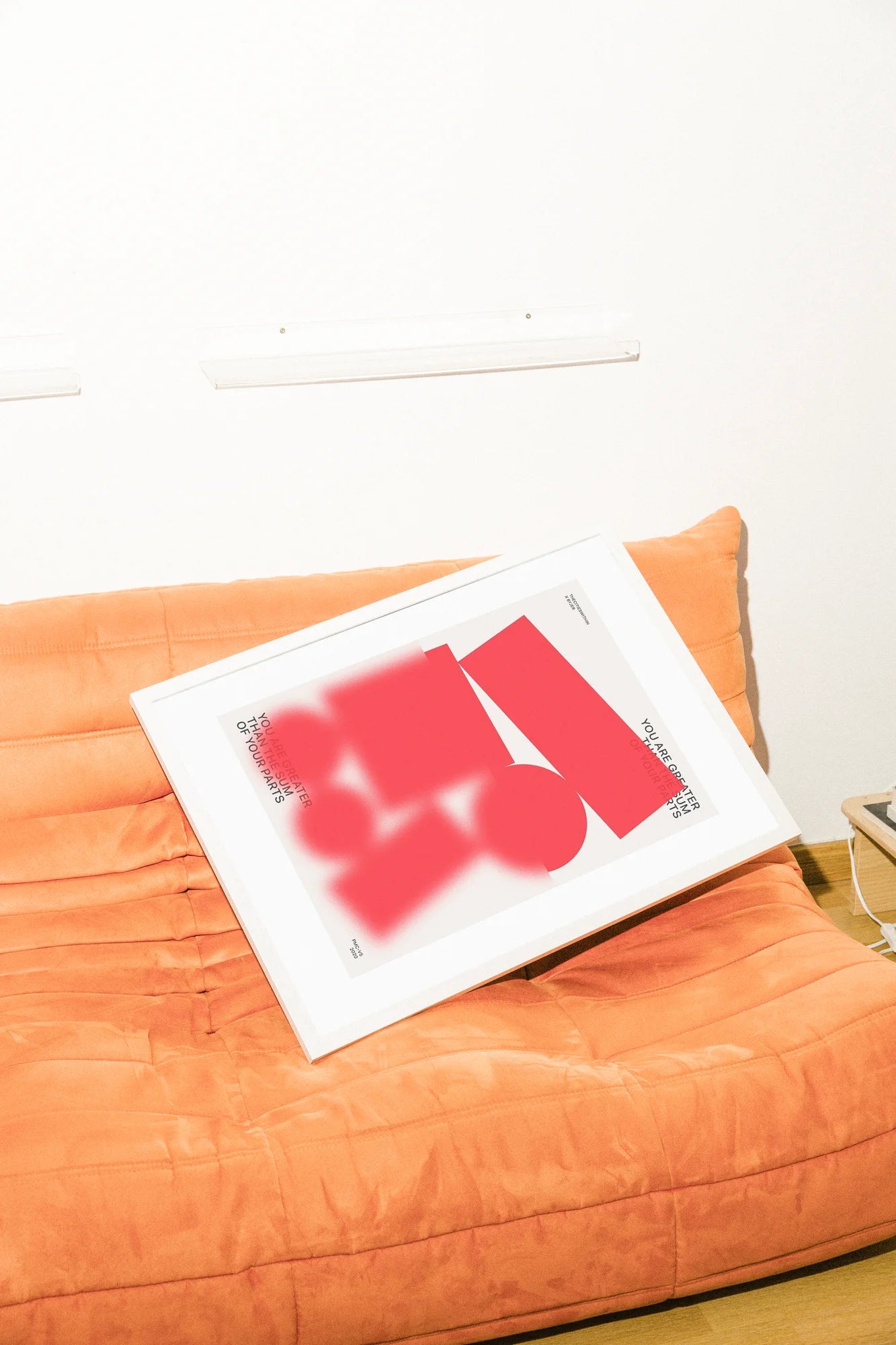 Une illustration numérique minimaliste présentant des formes abstraites rouges audacieuses sur un fond blanc éclatant, encadrant la phrase inspirante 'You Are Greater Than The Sum Of Your Parts'.. abstract, digital, minimalist, red, white