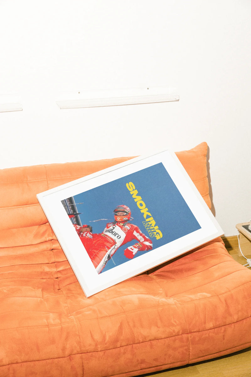 Une photo audacieuse capture un pilote de Formule 1 en rouge éclatant, sur une piste bleue austère avec un texte jaune provocateur défiant les habitudes modernes.. blue, bold, illustration, red, typographic, vibrant, yellow
